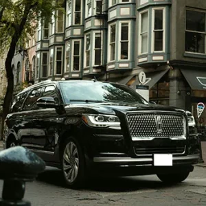 Luxury SUV parked on city street corner.