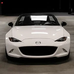 White sports car in dimly lit parking garage.